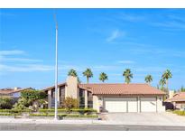 Charming single-story home features a three-car garage, red tile roof, and mature landscaping at 8620 Cremona Dr, Las Vegas, NV 89117