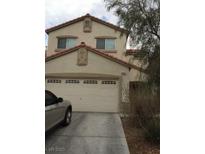 Two-story home featuring a two car garage and neutral color scheme at 9091 Jumping Jacks Ave, Las Vegas, NV 89178