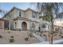 Charming two-story home features a landscaped yard and inviting arched entryway at 1328 Graphite Ave, Henderson, NV 89002