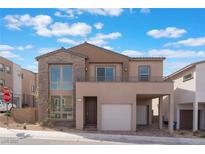 Contemporary two-story home with stone accents, private balcony, and attached two-car garage at 1785 Flycatch St, Las Vegas, NV 89138