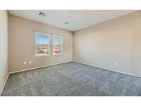 Neutral bedroom features plush carpet and windows providing natural light at 2088 Sawtooth Mountain Dr, Henderson, NV 89044