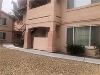 Inviting condominium exterior featuring a covered walkway and well-maintained landscaping at 350 S Durango Dr # 103, Las Vegas, NV 89145