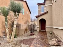 Charming home featuring a brick walkway, desert landscaping, and an arched entryway at 4520 Lemon Gems Ct, Las Vegas, NV 89130