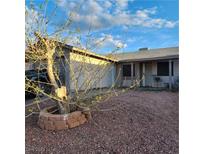 Charming single-story home with low-maintenance rock landscaping and mature tree in the front yard at 510 Holick Ave, Henderson, NV 89011