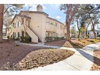 Charming multi-Gathering home featuring classic architecture and landscaped surroundings under a sunny sky at 5211 Caspian Springs Dr # 201, Las Vegas, NV 89120