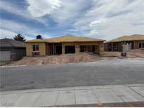 A new construction home featuring a light brown roof and framing, awaiting exterior finishes, promising a modern design at 579 Jerry Bird Ct, Las Vegas, NV 89123