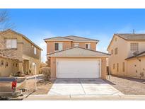 Two story tan home with a two car garage, tile roof, and well-kept lawn in a suburban neighborhood under a blue sky at 5935 Stone Hollow Ave, Las Vegas, NV 89156