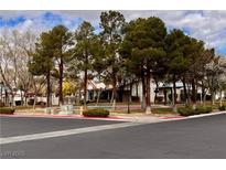 Community area with trees, sidewalks, and landscaped areas, creating an inviting outdoor space at 6237 Glimmering Light Ave, Las Vegas, NV 89139