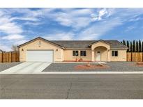 Charming single-story home featuring a neutral-colored exterior, arched entryway, and a two-car garage at 672 Lampshire Ln, Pahrump, NV 89060