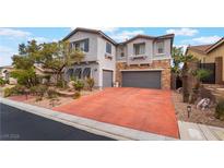 Charming two-story home with a stone facade, landscaped yard, and a spacious driveway at 872 Timber Walk Dr, Henderson, NV 89052