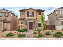 Two-story home with stone accents, desert landscaping, and a brick walkway at 1115 Brilliant Meadow Ave, North Las Vegas, NV 89086