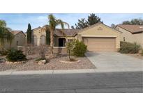 Charming single-story home with desert landscaping, a two-car garage and inviting curb appeal at 1654 Danbury Crossing Dr, Henderson, NV 89052