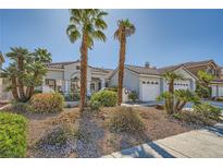 Charming single-story home features palm trees, a well-manicured lawn, and a welcoming facade at 2012 Lady Lake St, Las Vegas, NV 89128