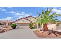 Charming single-story home with a two-car garage and desert landscaping at 2077 Wildwood Lake St, Henderson, NV 89052