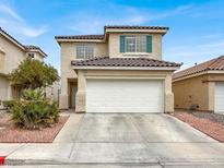 Charming two-story home with a well-maintained front yard and attached two-car garage at 2106 Polynesia Cir, Henderson, NV 89074