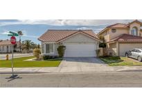 Charming single-story home featuring a well-manicured lawn, tile roof and a two-car garage at 301 Montcliff Ave, Henderson, NV 89074