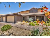 Charming single-story home featuring desert landscaping, a brick facade, and a three-car garage at 3130 Appleblossom Cir, Las Vegas, NV 89117
