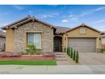 Charming single-story home featuring stone accents, a tile roof, and manicured landscaping at 3136 Pavilio Dr, Henderson, NV 89044