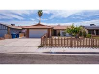 Charming single-story home featuring a quaint fenced yard and two-car garage at 325 Greenfield Ln, Las Vegas, NV 89107