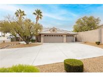 Charming home with a three-car garage, tile roof, and a desert-landscaped front yard at 3607 Bixbee Ct, Las Vegas, NV 89129