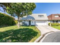 Charming home with a manicured lawn and a mature shade tree in front at 3727 Centennial Cir, Las Vegas, NV 89121