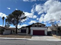 Charming single Gathering home with a two car garage, mature tree, and beautiful blue sky at 4417 De Forest St, Las Vegas, NV 89103