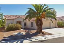 Inviting single-story home with a tile roof, desert landscaping, and a mature palm tree in the front yard at 4624 Standing Bluff Way, Las Vegas, NV 89130