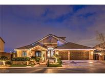Stunning two-story home showcasing manicured landscaping and a symmetrical facade with garage and covered entry at 4752 Rancho Camino Ct, Las Vegas, NV 89129
