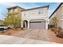 Charming two-story home featuring an attached two-car garage and a beautifully landscaped front yard at 5384 Knitmore Ct, Las Vegas, NV 89139