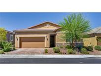Inviting single-story home with a two-car garage, desert landscaping, and brick-paved driveway at 5518 Taylor Rose Ave, Las Vegas, NV 89139