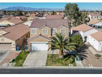 Aesthetic aerial view of a tan two-story home, with a desert landscaped yard, and gorgeous mountain backdrop at 5854 Heather Marie Dr, Las Vegas, NV 89110