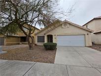 Charming single-story home with a two-car garage and well-maintained landscaping in a suburban neighborhood at 7209 London Bridge Ave, Las Vegas, NV 89130