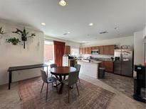 Open kitchen with granite countertops, stainless steel appliances, and dining area at 7749 W Diablo Dr, Las Vegas, NV 89113