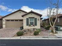 Charming single-story home featuring desert landscaping and a brick-paved driveway leading to a two-car garage at 7832 Hamilton Pool Dr, Las Vegas, NV 89113