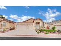 Charming single-story home featuring a three-car garage and manicured landscaping at 8624 Burning Hide Ave, Las Vegas, NV 89143