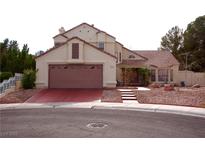 Charming two-story home with a well-manicured front yard and a spacious two-car garage at 9113 Anchor Cove Ct, Las Vegas, NV 89117
