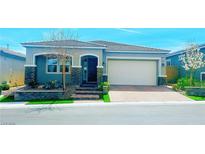 Charming single-story home featuring stone accents, a brick driveway, and well-maintained landscaping at 10067 Tamberlaine Ave, Las Vegas, NV 89178