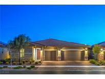 Charming single-story home featuring a two-car garage and desert landscaping, creating a welcoming curb appeal at 125 Ella Ashman Ave, Henderson, NV 89011