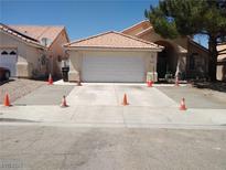 Charming home featuring a spacious two-car garage and a newly finished driveway at 1318 Misty View Ct, North Las Vegas, NV 89031