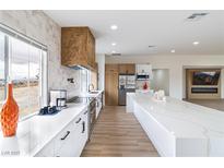 Bright kitchen featuring white cabinets, stainless steel appliances, and a large center island with Quartz countertops at 1891 Brian Rd, Pahrump, NV 89048