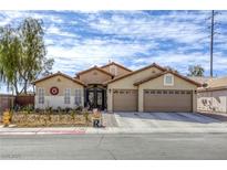 Charming single-story home featuring a two-car garage, desert landscaping, and a tile roof at 2625 Torch Ave, North Las Vegas, NV 89081
