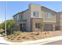 Charming two-story home featuring desert landscaping and stone accents on the facade and garage at 290 Mount Williamson St, Henderson, NV 89015