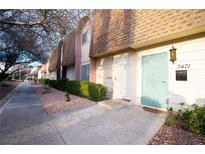 Inviting townhome featuring a tidy front yard, private entrance, and charming exterior details at 3467 Garden East Dr, Las Vegas, NV 89121