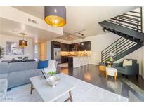 Bright and airy living room featuring modern furnishings, a stylish staircase, and an open floor plan at 353 E Bonneville Ave # 746, Las Vegas, NV 89101