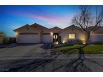 Charming single-story home featuring a three-car garage, landscaped front yard and inviting double-door entrance at 3837 Genoa Dr, Las Vegas, NV 89141