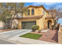 Charming two-story home featuring a green two-car garage, and low maintenance desert landscaping at 5218 Andreas Canyon Ct, Las Vegas, NV 89139