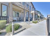 Charming townhomes with stone accents and covered patios provide a welcoming curb appeal at 6434 Spring Jog St, Las Vegas, NV 89166