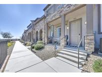 Charming townhouse exterior with stone accents, covered porch, and well-maintained landscaping at 6434 Spring Jog St, Las Vegas, NV 89166