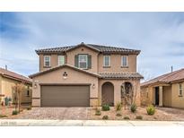 Inviting two-story home with a well-maintained front yard, covered entry, and an attached two-car garage at 6904 Baylor Creek St, North Las Vegas, NV 89086