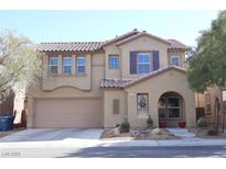 Charming two-story home featuring a tile roof, desert landscaping, and a two-car garage at 7185 Neches Ave, Las Vegas, NV 89179